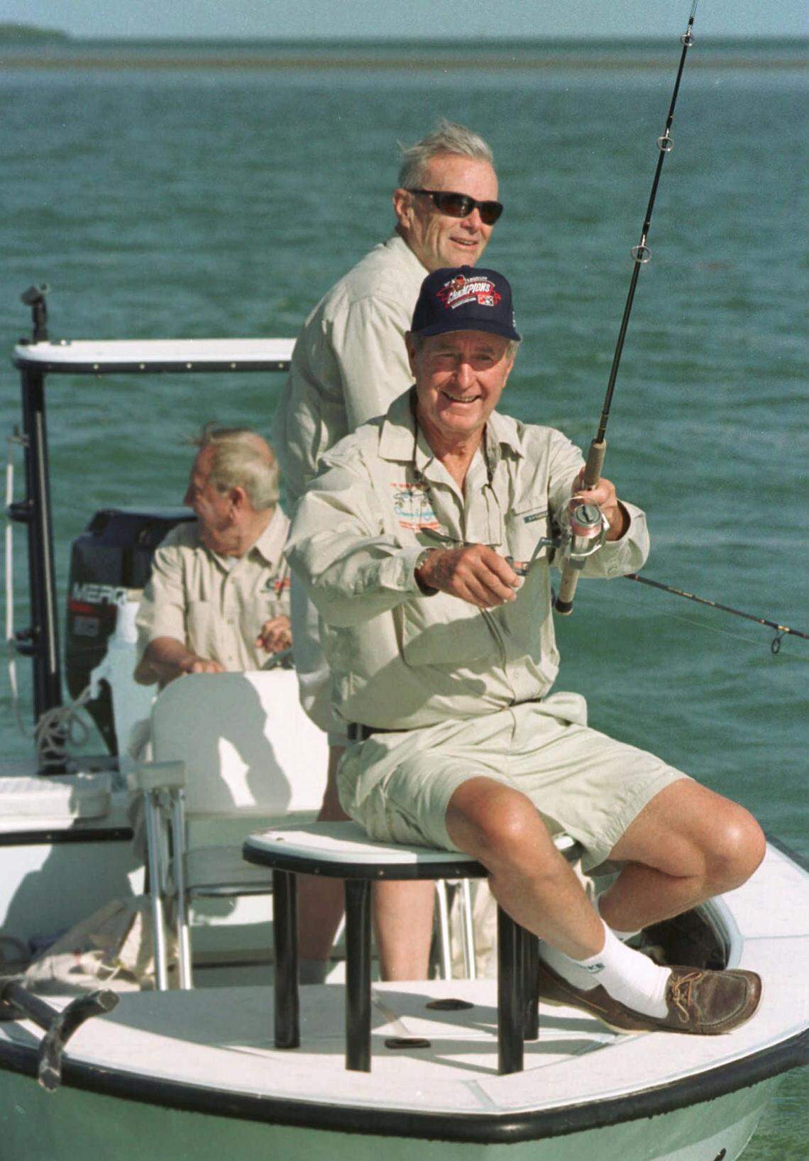 Former President George Bush retrieves his bait off Islamorada Key, Fla., Wednesday, Oct. 8, 1997, during the first day of the George Bush/Cheeca Lodge Bonefish Tournament in the Florida Keys. Behind Bush is former treasury secretary Nicholas Brady and, at rear, George Hommell, a longtime Bush friend and Keys fishing guide. Bush was unsuccessful in catching a bonefish Wednesday but predicted that the final day of the tournament, Thursday, would provide better results. The contest which has attracted 56 anglers serves as a fund-raiser for The Nature Conservancy and Bush’s forthcoming library center. (AP Photo/Florida Keys Tourism Bureau, Andy Newman)