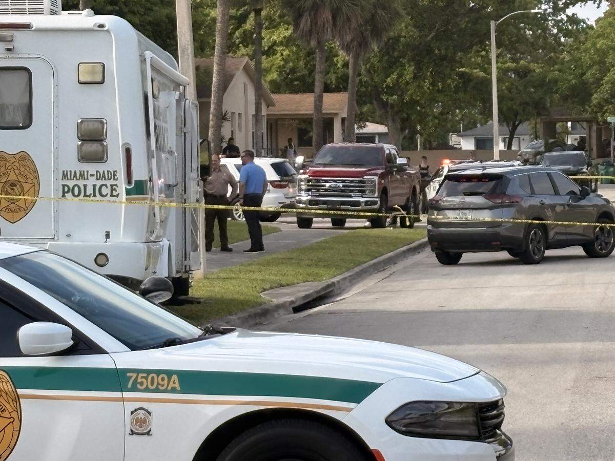 Miami-Dade Sheriff’s Office deputies and detectives gather along Southwest 112th Avenue and 221st Street, where a deputy shot a person on Thursday, April 2, 2026.