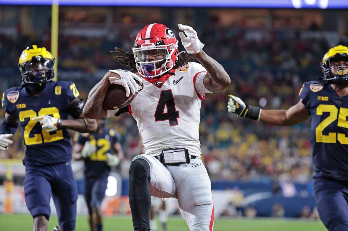 Georgia Bulldogs running back James Cook (4) scores in the fourth quarter against Michigan Wolverines during the 2021 College Football Playoff Semifinal at the Capital One Orange Bowl hosted at Hard Rock Stadium in Miami Gardens, Florida, on Friday, December 31, 2021.