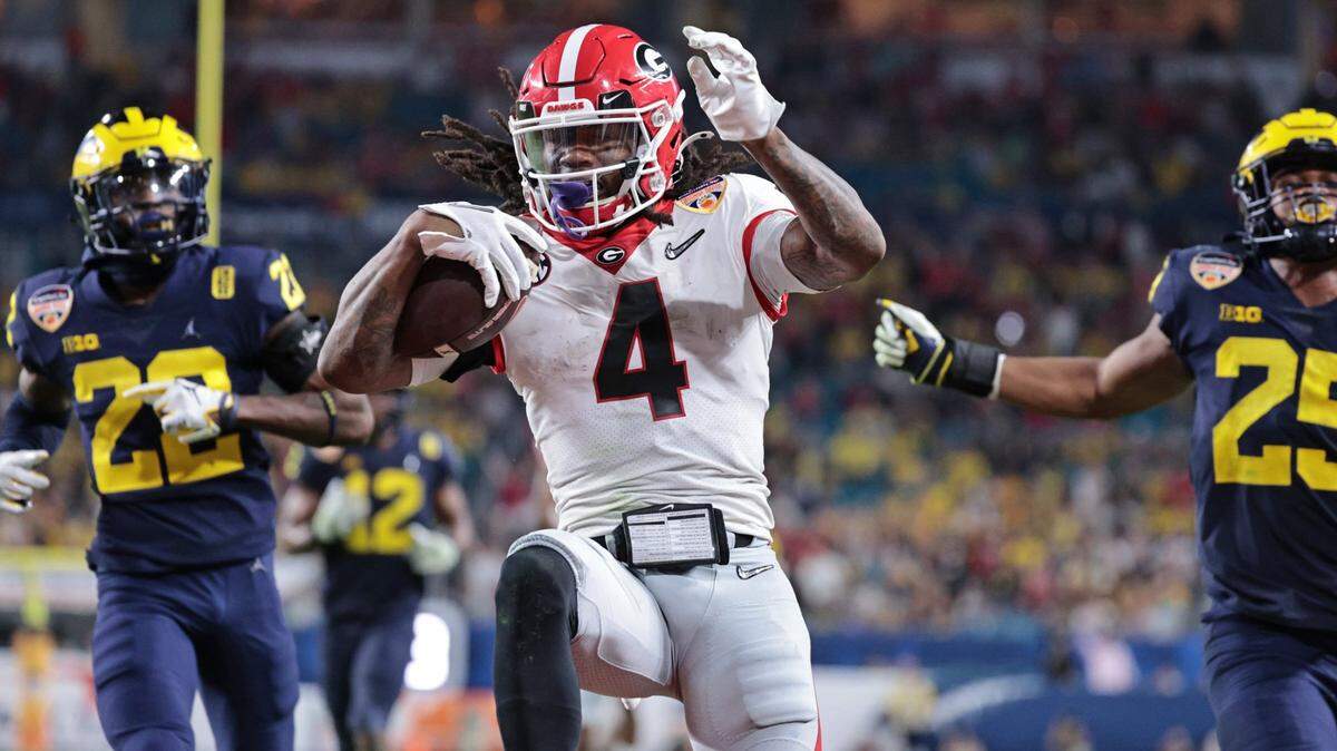 Georgia Bulldogs running back James Cook (4) scores in the fourth quarter against Michigan Wolverines during the 2021 College Football Playoff Semifinal at the Capital One Orange Bowl hosted at Hard Rock Stadium in Miami Gardens, Florida, on Friday, December 31, 2021.