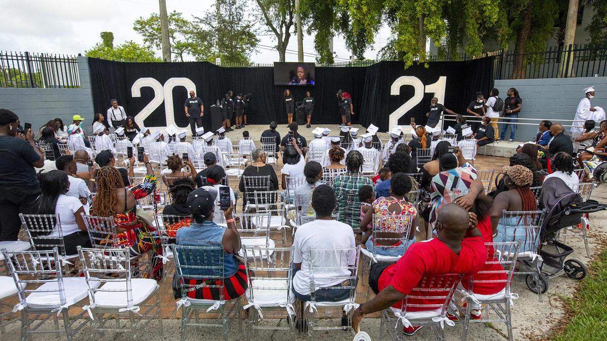 Family and friends gather at African Square Park during a special Juneteenth Commencement Celebration at M.E.Y.G.A. (Multi-Ethnic Youth Group Association) Learning Center Liberty City, Florida, on Saturday, June 19, 2021. The event honored the newly created federal holiday of Juneteenth and celebrated the graduation of M.E.Y.G.A. students.