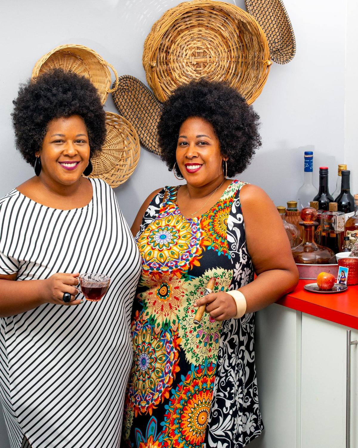 Business co-owners Yvette and Yvonne Rodriguez, of Tres Lindas Cubanas Cigars, drink coffee and smoke a cigar at one sister’s home near the Dadeland area of Miami, Florida, on Friday, August 13, 2021.