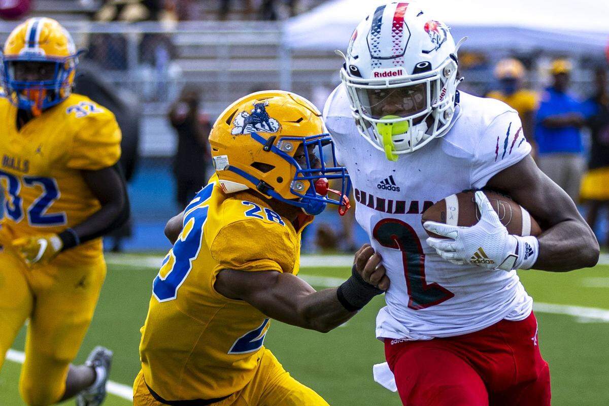 Chaminade-Madonna wide receiver Edwin Joseph (2) runs with ball after a catch while guarded by Miami Northwestern defensive back Kamron Brantley (28) during a high school football game at Nathaniel Traz Powell Stadium in Westview, Florida, on Saturday, September 10, 2022.