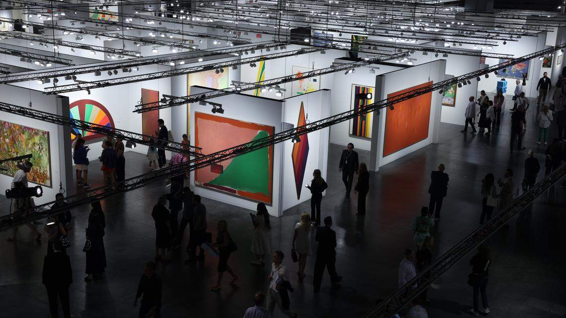 Fair goers scope the many booths of Art Basel Miami Beach on its opening day of the 23rd annual Art Basel in Miami Beach, Florida on Wednesday, December 3, 2025. The 23rd edition of Art Basel Miami Beach kicked off Wednesday as VIPs surveyed the collection of international and local galleries.