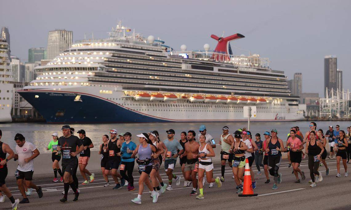 Runners run eastward passing the Carnival Horizon docked at the Port of Miami during Life Time Miami Marathon on Sunday, January 28, 2024 in Miami.