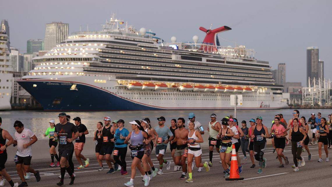 Runners run eastward passing the Carnival Horizon docked at the Port of Miami during the Life Time Miami Marathon on Sunday, Jan. 28, 2024, in Miami.