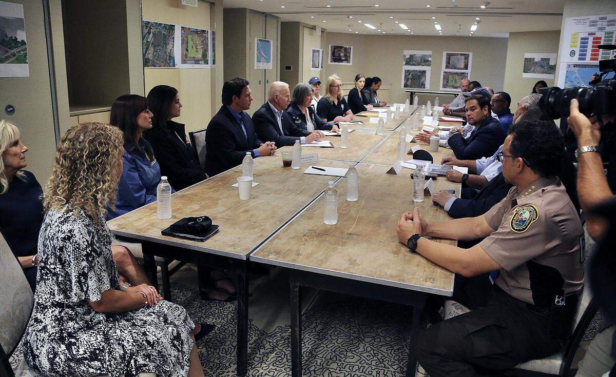 Burkett (left, wearing baseball cap) attends a meeting with President Joe Biden at the St. Regis Hotel on July 1, 2021.