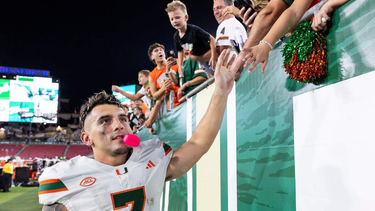 Miami Hurricanes wide receiver Xavier Restrepo (7) high fives fans after defeating the South Florida Bulls in their NCAA college football game at the Raymond James Stadium on Saturday, Sept. 21, 2024, in Tampa, Fla.