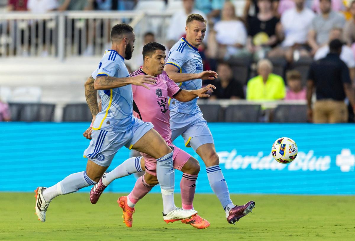 Inter Miami forward Luis Suárez (9) competes for the ball against Atlanta United defender Derrick Williams (3) in the first half of an MLS match at Chase Stadium on Wednesday, May 29, 2024, in Fort Lauderdale, Fla.