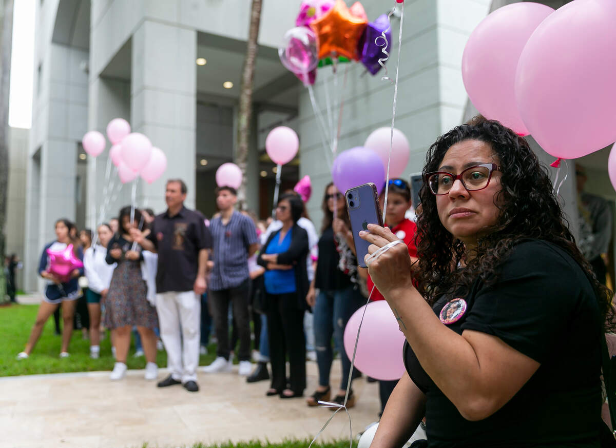 Family and friends attend the unveiling of a memorial at Florida International University in Miami, Florida on the fourth anniversary of the FIU bridge collapse on Tuesday, March 15, 2022. The bronze statue, which was made by Brian Hanlon, commemorates former FIU student Alexa Duran and the other five victims who were killed when a pedestrian bridge, still underway, collapsed on March 15, 2018.