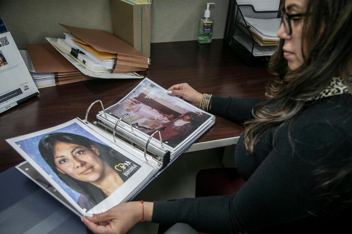 Homestead Detective Jennifer Roa looks through a folder with pictures and documents of Maribel Oquendo. Detective Roa is trying to solve the 1982 disappearance of 9-year-old Maribel, who vanished after buying candy at a local market.