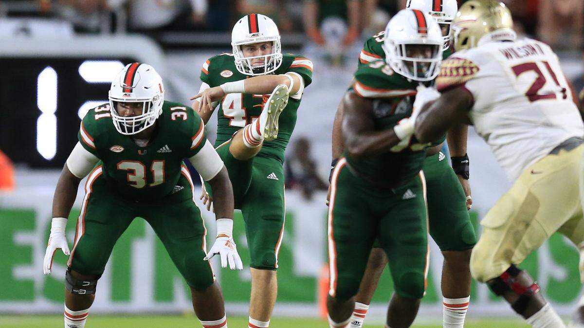 Miami Hurricanes punter Jack Spicer (43) punts in the fourth quarter as the University of Miami host Florida State University at Hard Rock Stadium in Miami Gardens on Saturday, October 6, 2018.