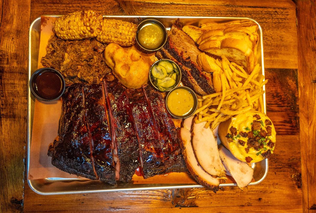 An order of pork ribs, pulled pork, brisket, smoked turkey, mac and cheese, fried corn, corn bread and fries from at Apocalypse BBQ.