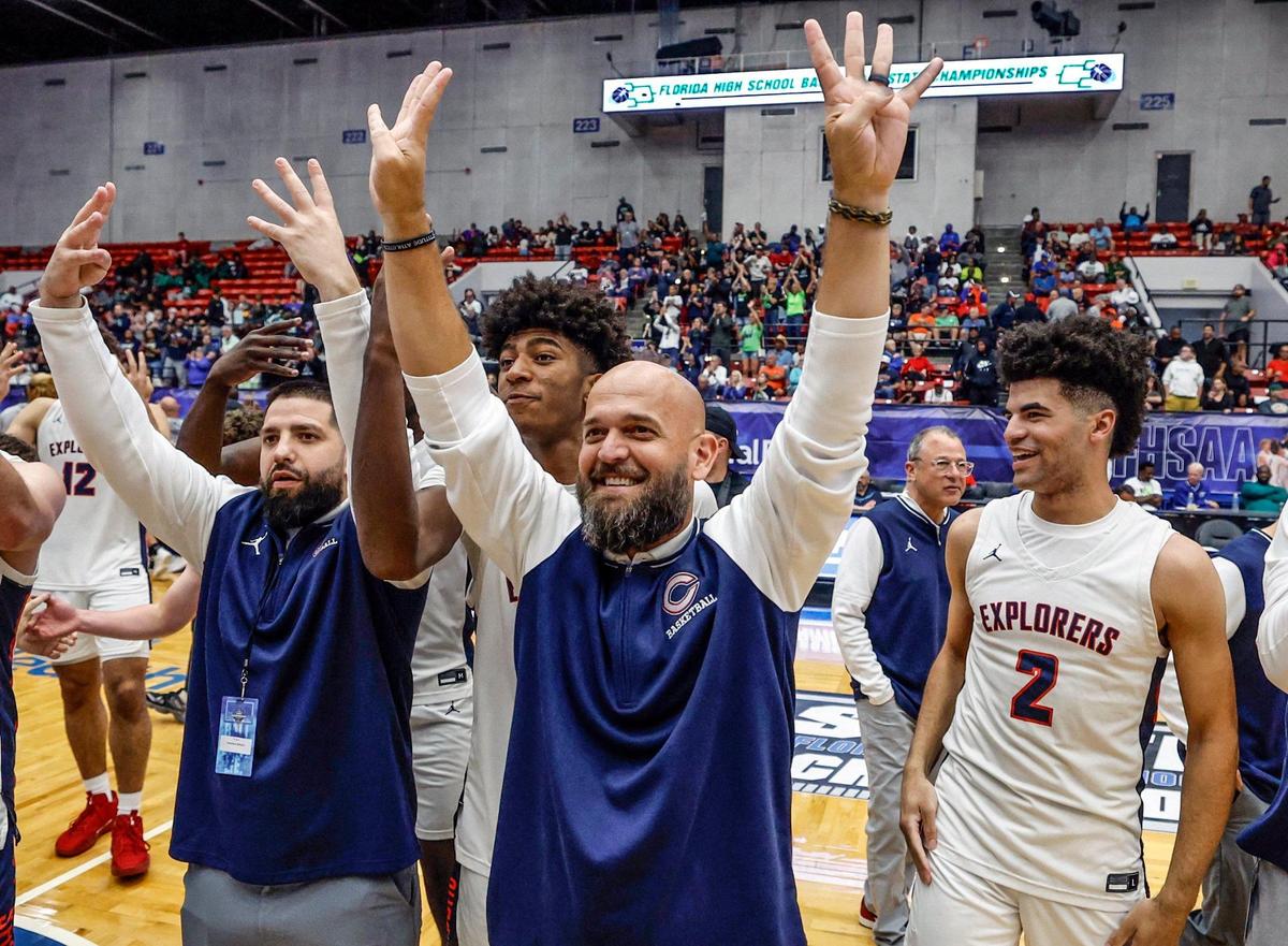 Columbus head coach Andrew Moran, at center, celebrates with the team after Columbus defeats Windermere in the for the FHSAA Class 7A Final in the Boys High School Basketball State Championship at the RP Funding Center in Lakeland, Florida on Saturday, March 8, 2025.