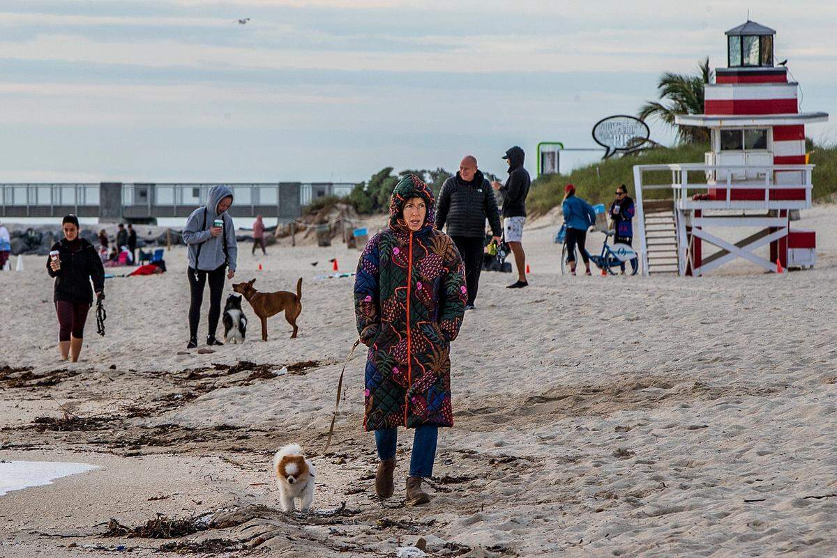 As Miami hit a low of 48 around 6 a.m. Saturday, Lia Ducket and her dog Luke, a 5 y.o. Pomeranian walk along the beach in South Pointe, Miami Beach, despite the cold temperatures affecting Florida that will continue through the holiday weekend with another bracing upper 40s start Christmas morning and temperatures only reaching about 58 Sunday afternoon, on Saturday December 24, 2022.