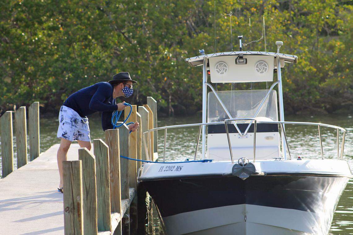 A man ties his center console boat to the dock at Blackpoint Marina Wednesday, April 29, 2020, the first day the county opened marinas and parks after closing them six weeks earlier due to the novel coronavirus pandemic.