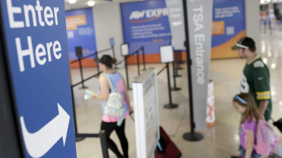A family is seen entering TSA at Appleton International Airport in 2022, in Greenville.