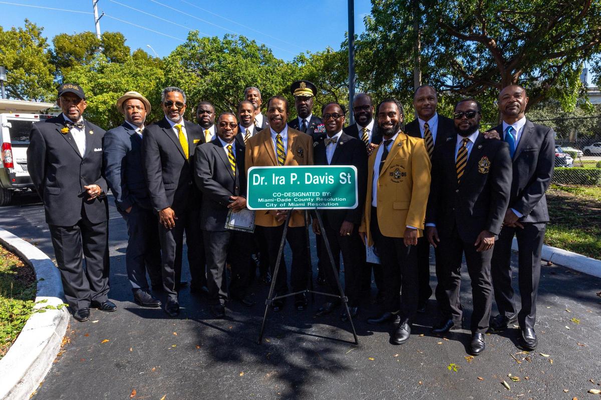 Members of the Alpha Phi Alpha fraternity stand behind the newly designated street sign bearing the name of of their fellow brother Dr. Ira P. Davis during a street renaming ceremony in honor of civil rights activist Dr. Ira P. Davis at the Historic Black Police Precinct & Courthouse in Miami, Florida, on Friday, November 17, 2023. 16th Street was renamed to ‘Dr. Ira P. Davis St’ between Second and Third Avenue.