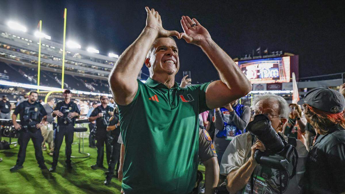 Miami Hurricanes head coach Mario Cristobal flashes the U after the Hurricanes defeat the Florida State Seminoles during their NCAA game at Doak Campbell Stadium in Tallahassee, Florida, on Saturday, October 4, 2025.