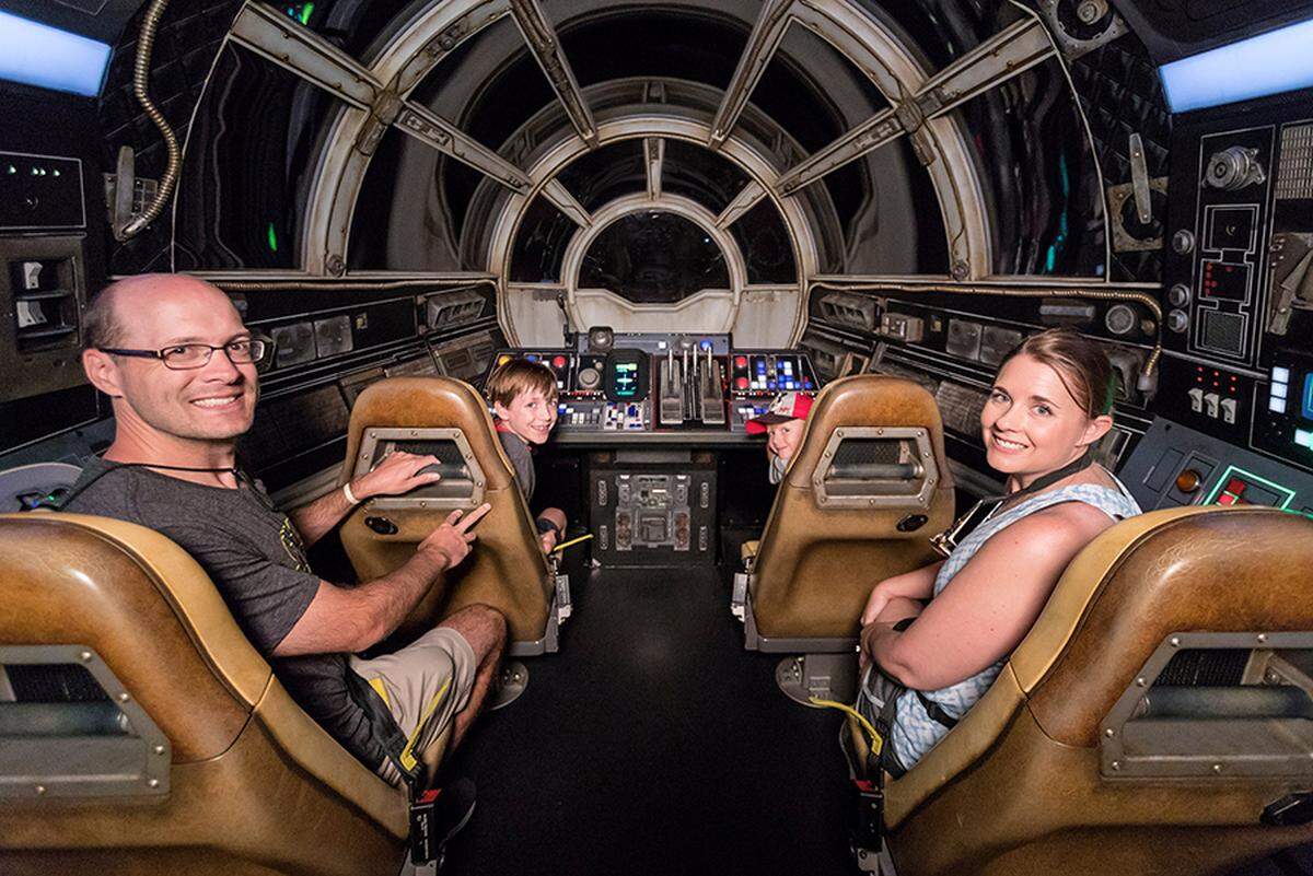 The Ridgeway family, the millionth riders of the Millennium Falcon: Smugglers Run attraction, take their turn on the ride.