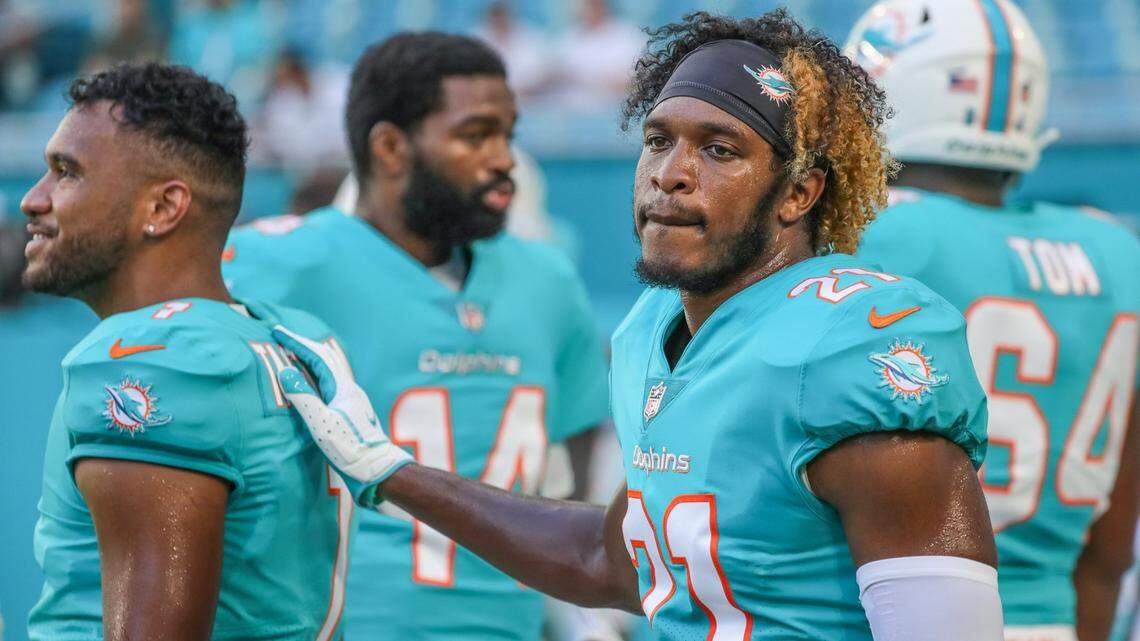 Miami Dolphins cornerback Eric Rowe (21) on the sidelines with quarterback Tua Tagovailoa (1) as the Miami Dolphins host the Atlanta Falcons at Hard Rock Stadium in Miami Gardens on Saturday, August 21, 2021.