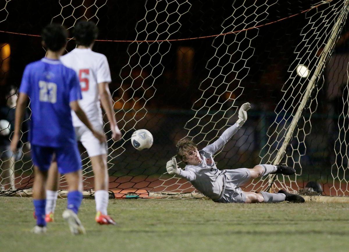 Coral Gables goalie Keller Evans (1) makes a save during the Region 4-7A boys’ soccer semifinal against Cypress Bay on Friday, February 16, 2024 at Cypress Bay HS in Weston.