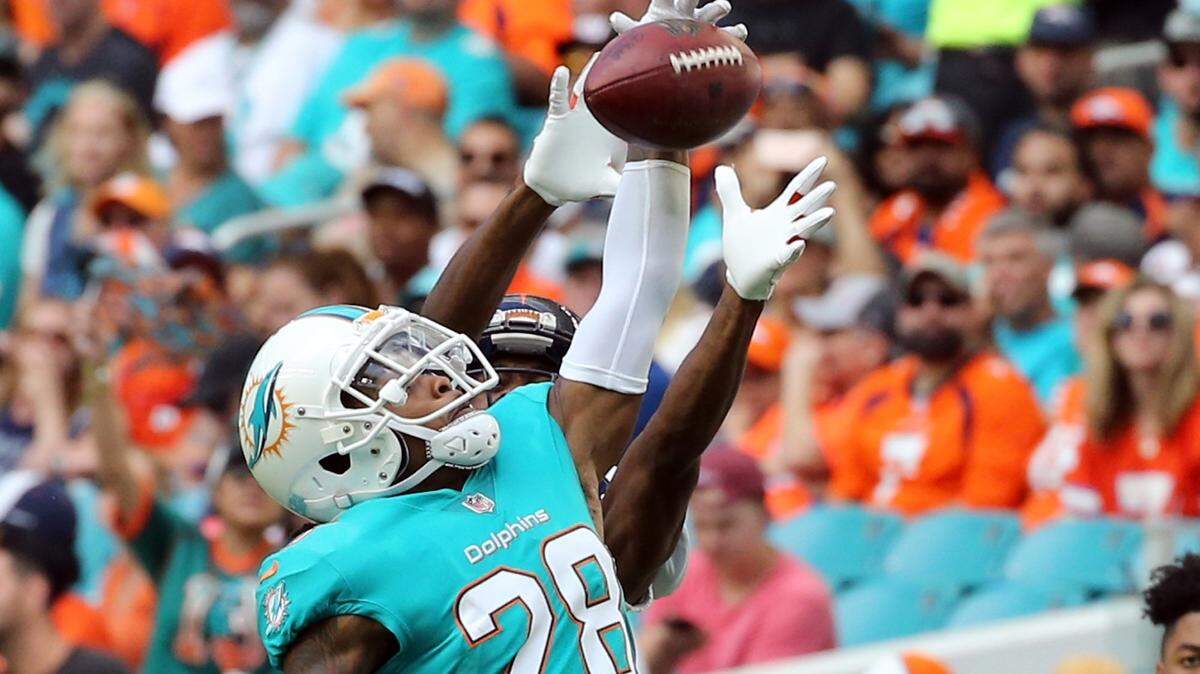 Miami Dolphins cornerback Bobby McCain (28) breaks up a pass against December last October. McCain and Danny Amendola had an incident during Monday’s practice, the first in full pads.
