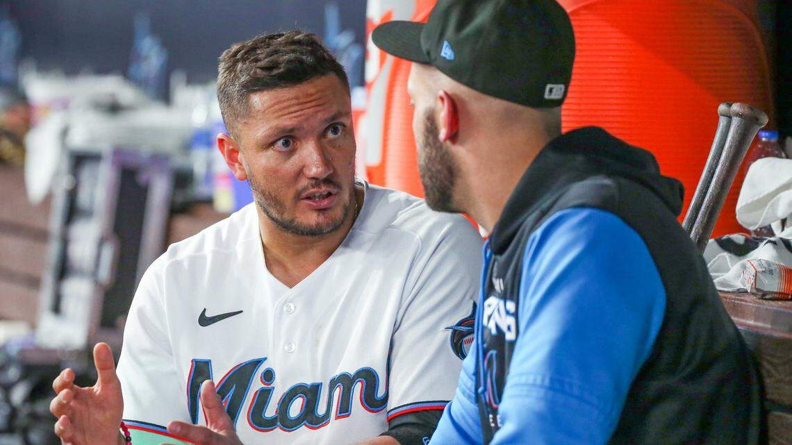 Miami Marlins shortstop Miguel Rojas (11) speaks with Miami Marlins catcher Jacob Stallings (58) in the dugout during game against the Washington Nationals at loanDepot park in Miami on Tuesday, June 7, 2022.