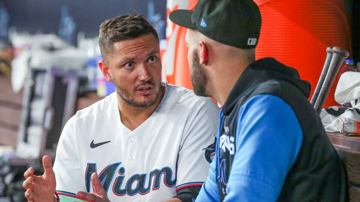 Miami Marlins shortstop Miguel Rojas (11) speaks with Miami Marlins catcher Jacob Stallings (58) in the dugout during game against the Washington Nationals at loanDepot park in Miami on Tuesday, June 7, 2022.