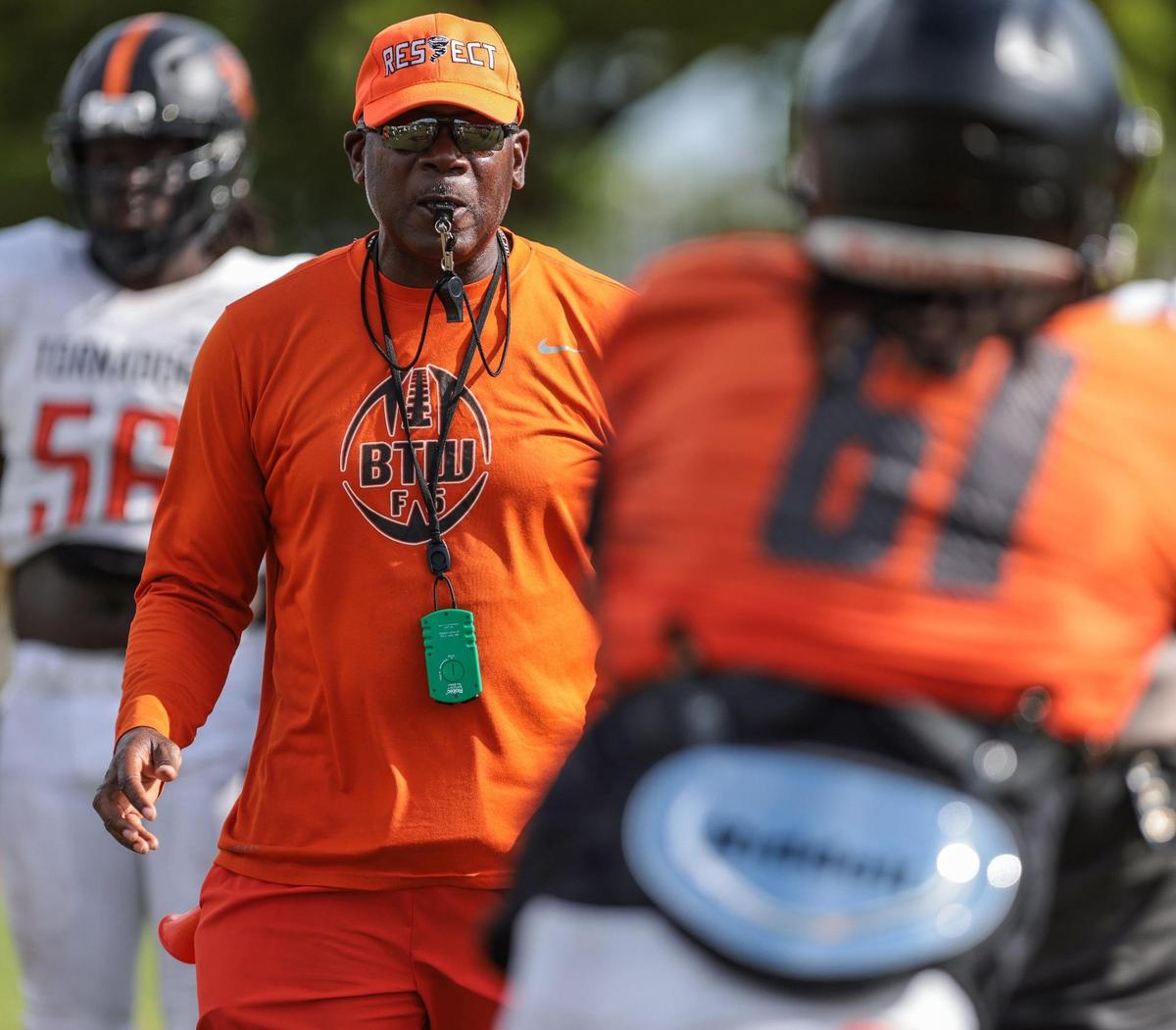On Monday, August 8, 2022 Booker T. head football coach Tim “Ice” Harris, left, holds practice at Booker T. Washington High School in Miami, Florida.