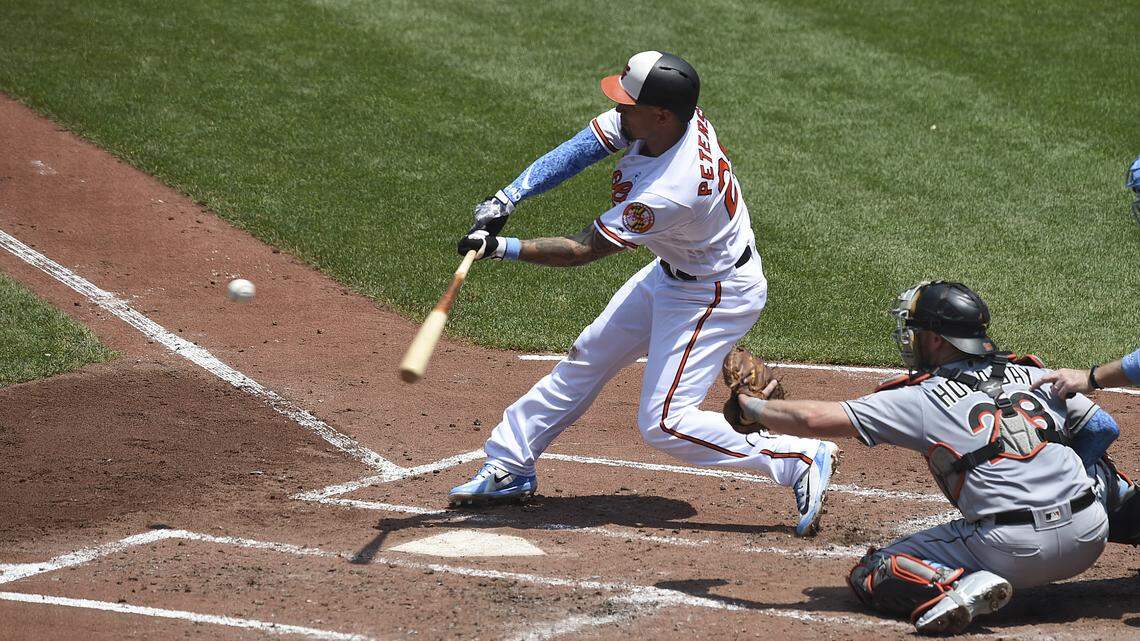 Baltimore Orioles' Jace Peterson connects for a two-run double against the Miami Marlins in the second inning of baseball game, Sunday, June 17, 2018, in Baltimore.
