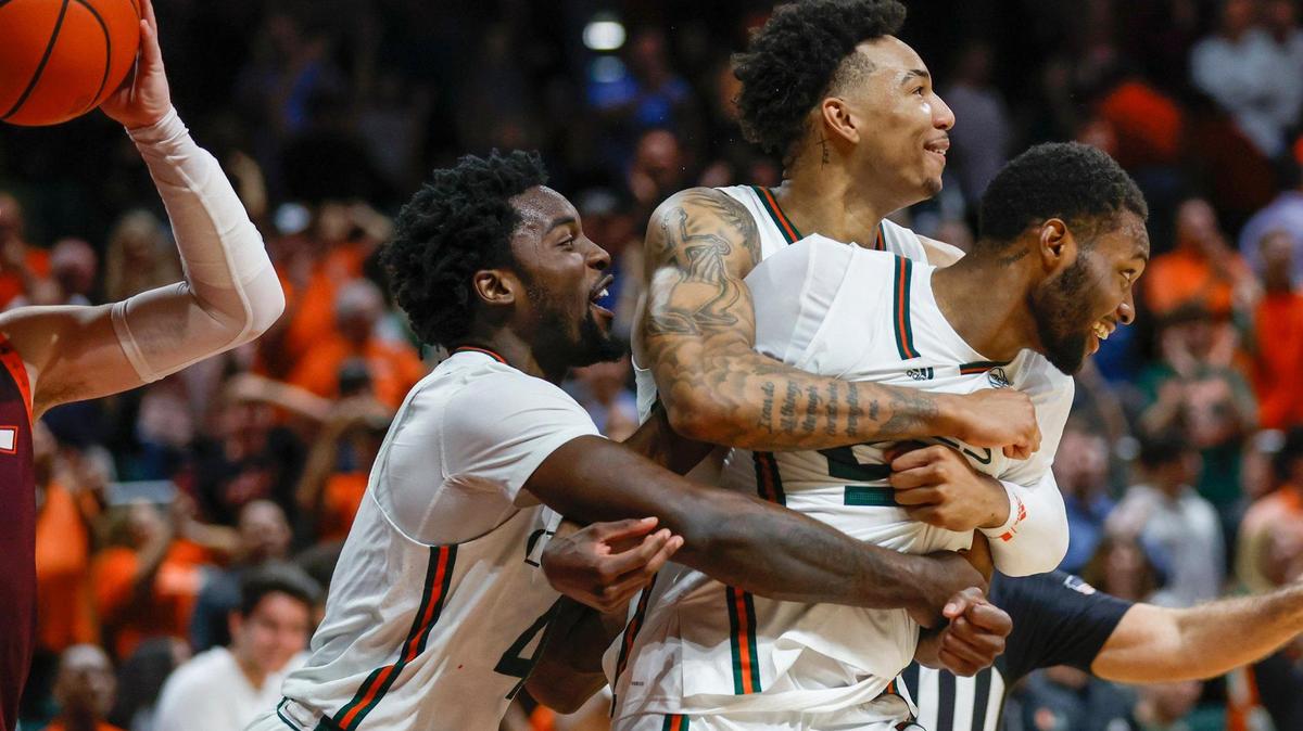 Miami Hurricanes guard Wooga Poplar (55) celebrates with teammates guard Bensley Joseph (4) and guard Jordan Miller (11) after dunking the ball in the final minutes of the second half against Virginia Tech Hokies at Watsco Center in Coral Gables, Florida on Tuesday, January 31, 2023.