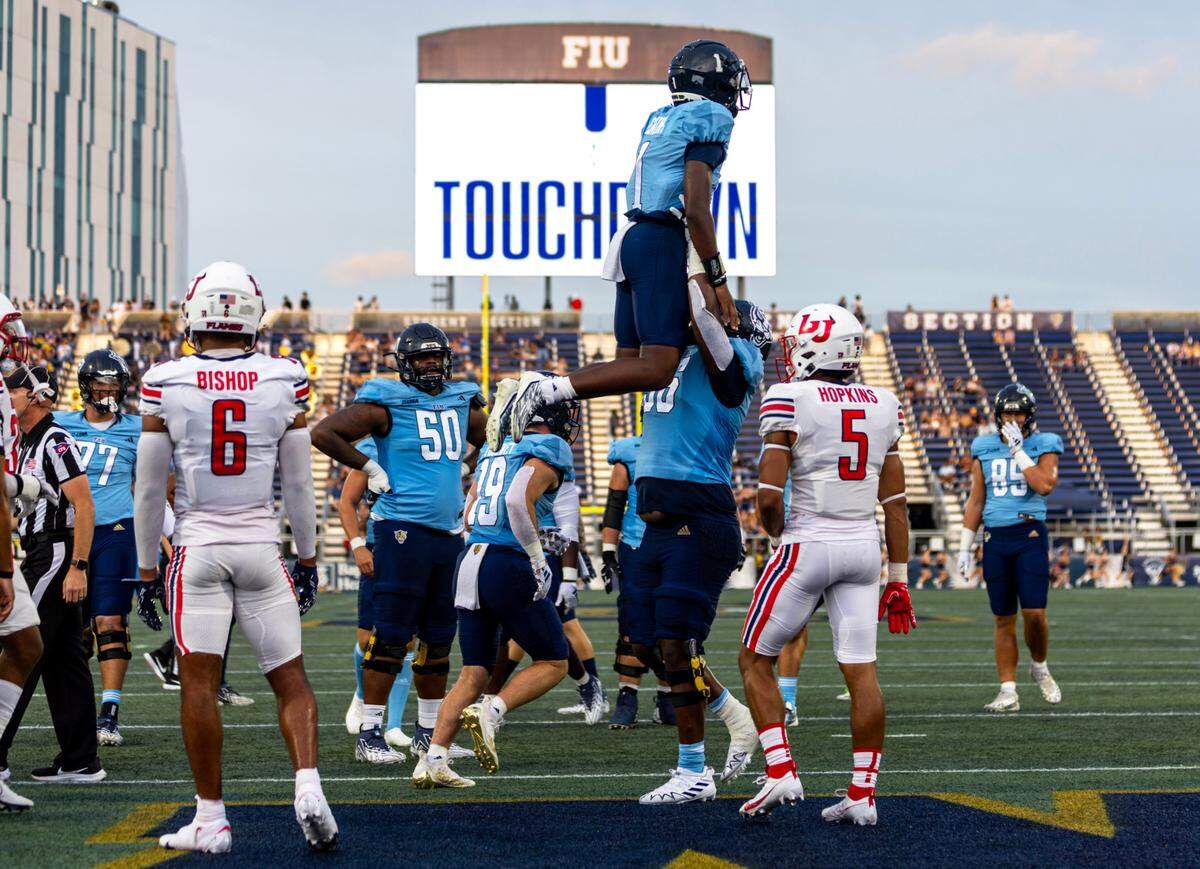 Florida International University quarterback Keyone Jenkins (1) is lifted in the air to celebrate a touchdown during the first half of a college football game against Liberty University at Riccardo Silva Stadium in Miami, Florida, on Saturday, September 23, 2023.