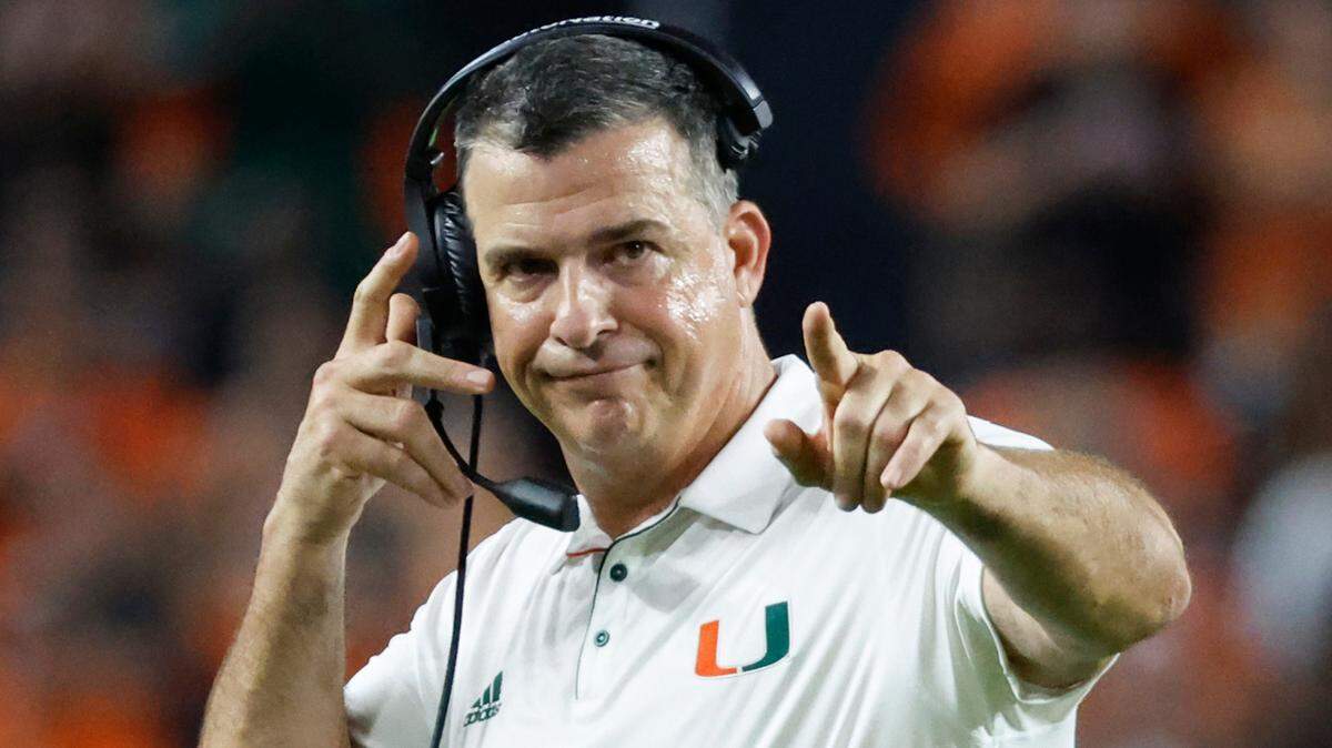 Miami Hurricanes head coach Mario Cristobal signals towards a game official during the first half of an ACC conference football game against the Virginia Tech Hokies at Hard Rock Stadium on Friday, September 27, 2024, in Miami Gardens, Fla.