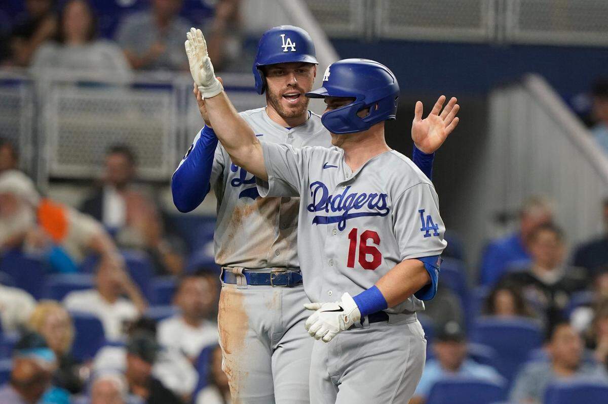 Los Angeles Dodgers’ Freddie Freeman congratulates Will Smith (16) after Smith scored a two-run home run in the third inning of a baseball game against the Miami Marlins, Monday, Aug. 29, 2022, in Miami. (AP Photo/Marta Lavandier)