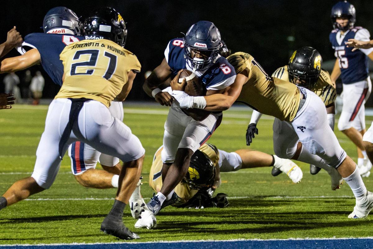 Columbus running back Edward Bandy (6) scores a touchdown as he’s tackled by a Western defender during the second half of an FHSAA football playoff game at Tropical Park in Miami, Florida, on Friday, November 24, 2023.
