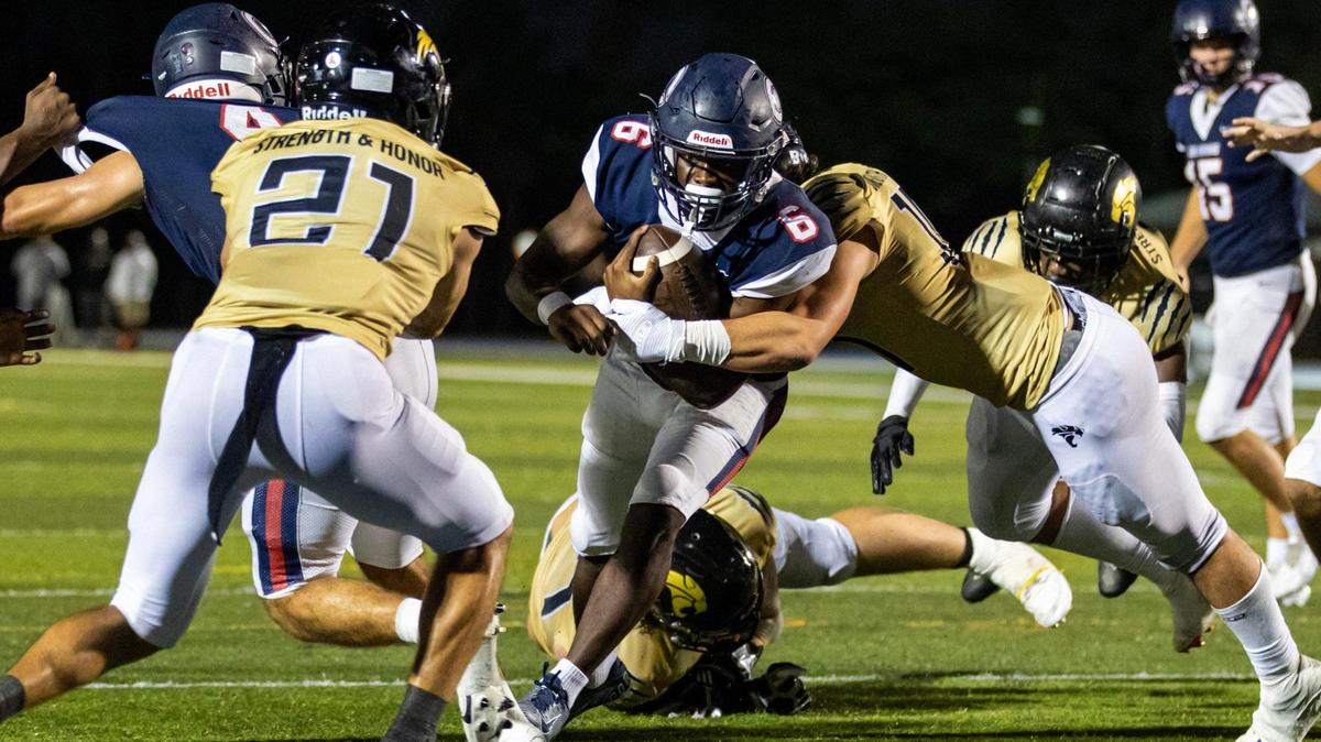 Columbus running back Edward Bandy (6) scores a touchdown as he is tackled by a Western defender during the second half of the Region 4-4M final at Tropical Park in Miami, Florida, on Friday, November 24, 2023.