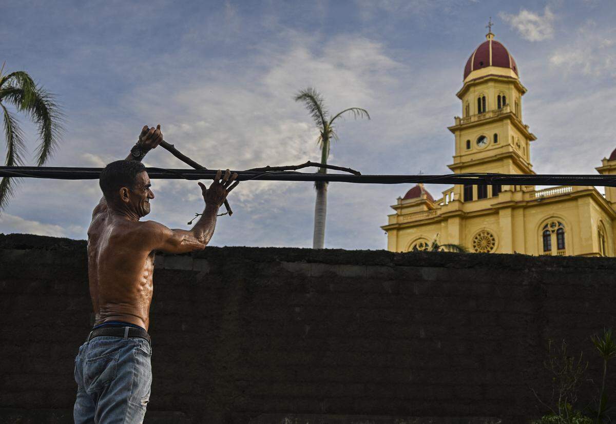 A resident of El Cobre, in the province of Santiago de Cuba, recovers parts of his damaged house after the passage of Hurricane Melissa, on October 29, 2025.     
