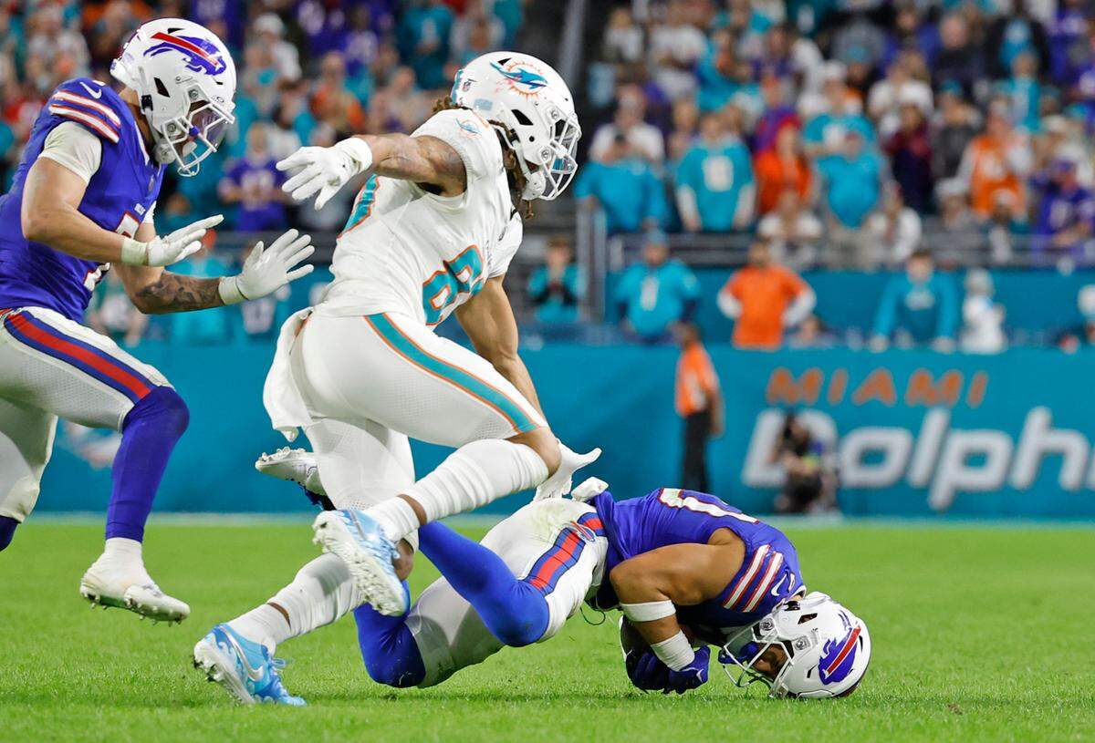 Buffalo Bills safety Taylor Rapp (20) intercepts the ball intended for Miami Dolphins wide receiver Chase Claypool (83) late in the fourth quarter during the game against the Buffalo Bills at Hard Rock Stadium in Miami Gardens on Sunday, January 7, 2024.