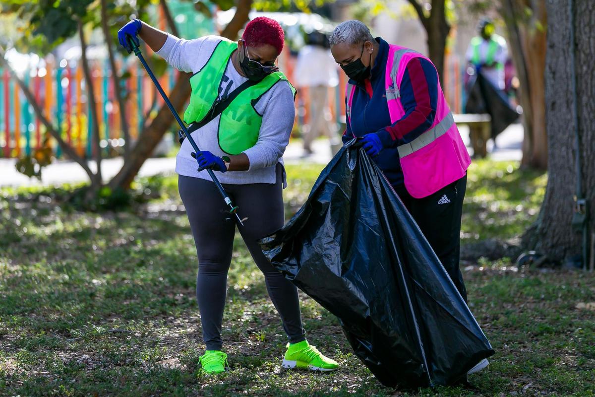 Carla Camps, 40, left, and Sherra Durham-Camp, 51, participate in a Community Cleanup at Magnolia Park in Opa-locka, Florida on Saturday, January 30, 2021. Miami-Dade County Commission Vice Chairman Oliver G. Gilbert, III, and Opa-locka Vice Mayor Veronica Williams hosted the event.