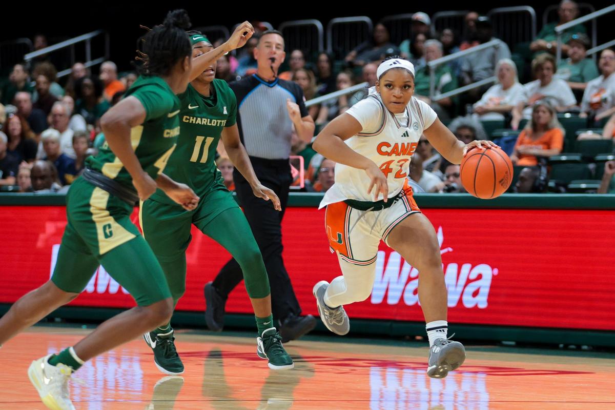 Miami Hurricanes guard Leah Harmon (42) drives to the basket past Charlotte 49ers guard Madison Roshelle (11) during the second quarter at Watsco Center in Coral Gables, Florida, Friday, November 29, 2024.