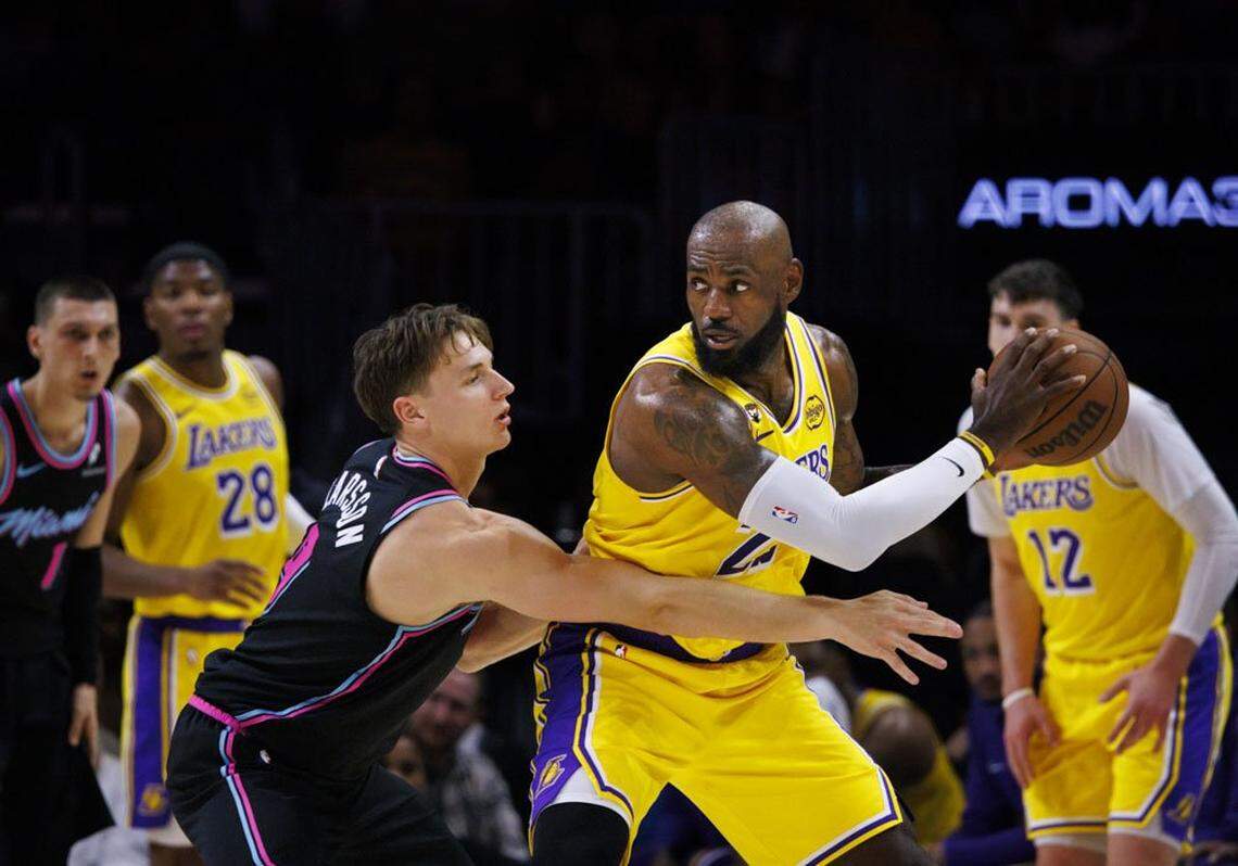 Miami Heat guard Pelle Larsson (9) guards Los Angeles Lakers forward LeBron James (23) during the first half of a game on Thursday, March 19, 2026, at the Kaseya Center in downtown Miami, Fla.