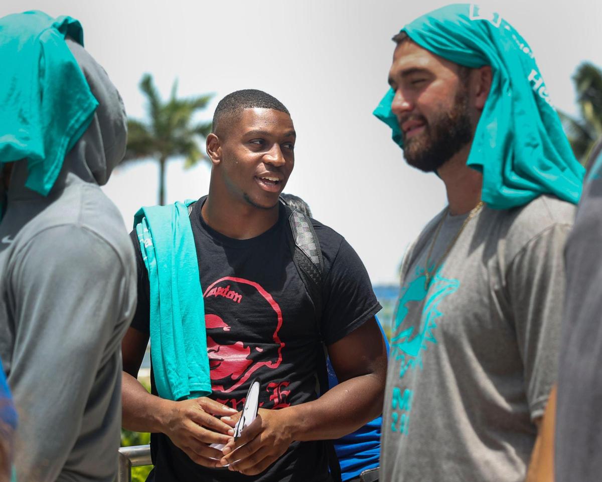 Channing Tindall, left, and Skylar Thompson, signed members of the Miami Dolphins rookie class, talk during a historic walking tour of Downtown Miami with local community groups on Wednesday, June 15, 2022, beginning with tour leaders at the History Miami Museum. Tindall and Thompson are two of the four players of the rookie class signed to the roster for this coming season.