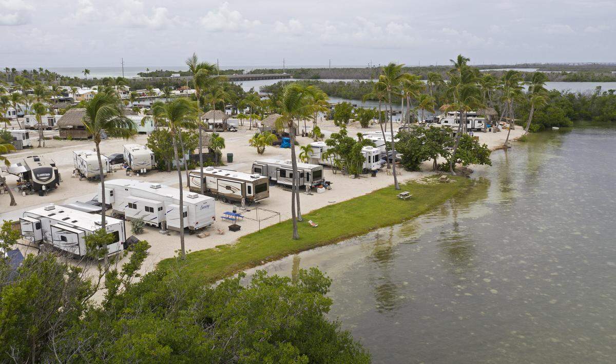 This aerial photo shows recreational vehicles parked Monday, Sept. 10, 2018, at Sunshine Key RV Resort near Big Pine Key, Fla., in the Florida Keys. The 75-acre, 399-site property was pummeled by Hurricane Irma on Sept. 10, 2017. A year later it formally reopened to guests with 100 sites ready. Resort officials said that all sites will be ready on Oct. 1.