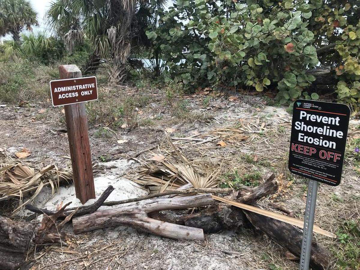 Signs at the Jupiter Inlet Lighthouse Outstanding Natural Area warn visitors to keep out of areas prone to erosion.