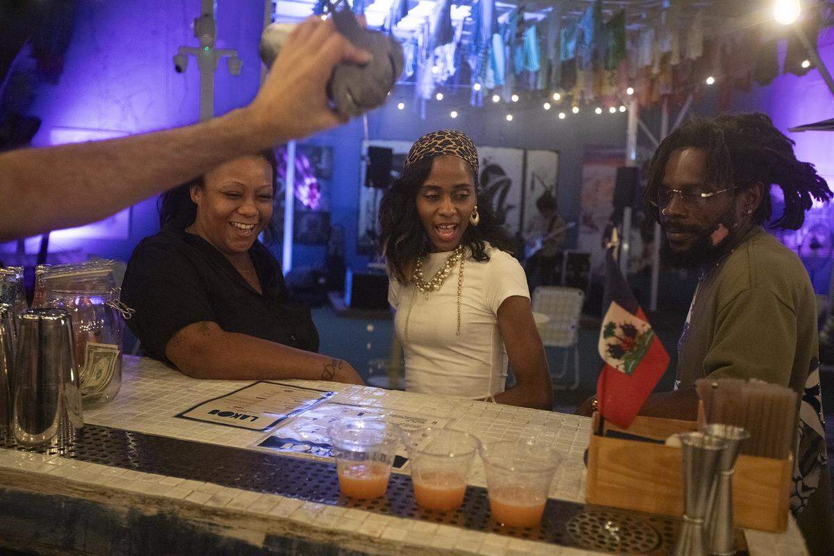 (L to R) Makeda Blake, Dolly Peppermint, and Evan's Mine (CQ) get some shots at Lakou Miami in Little Haiti, on Saturday October 25th., 2025.