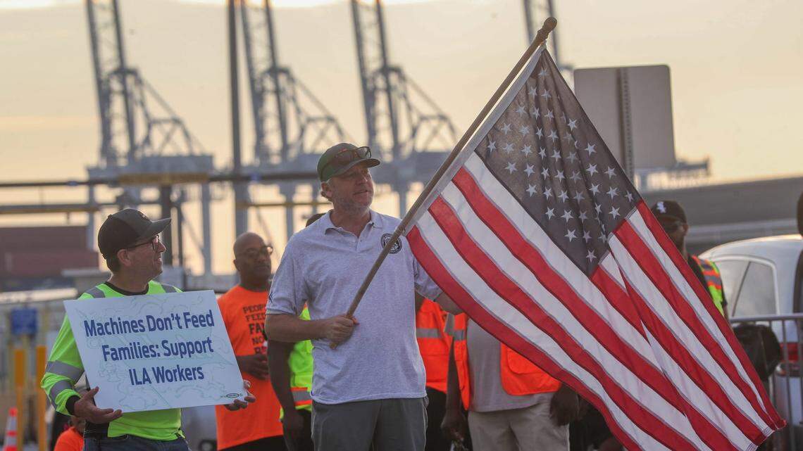 An International Longshoremen’s Association (ILA) member holds an American flag on the picket line on Oct. 1 as the ILA went on strike at the Georgia Ports Authority in Garden City, Ga.