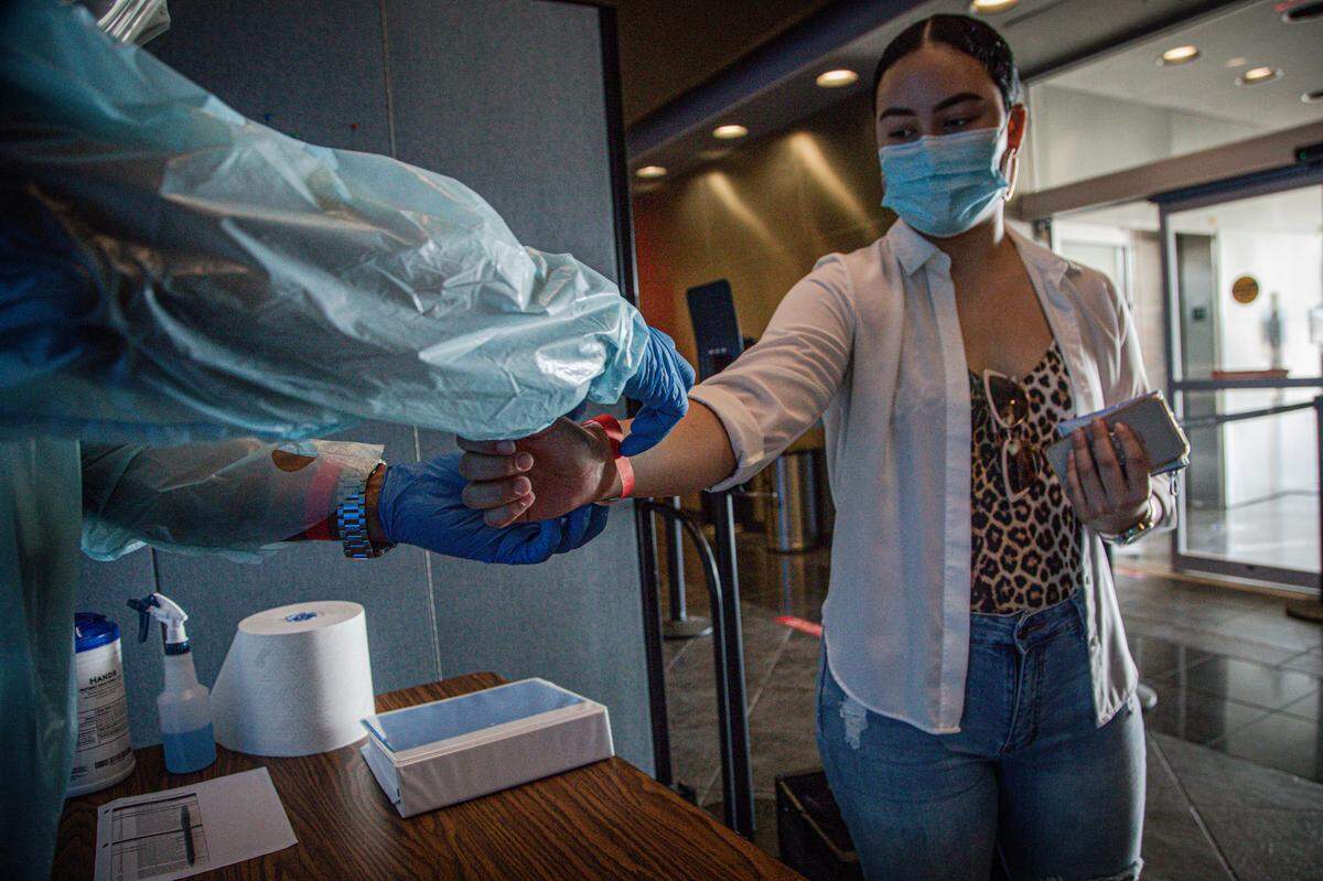 Miami Dade College students and staff get the temperature checked when they arrive to the Wolfson Campus check point on June 23, 2020.