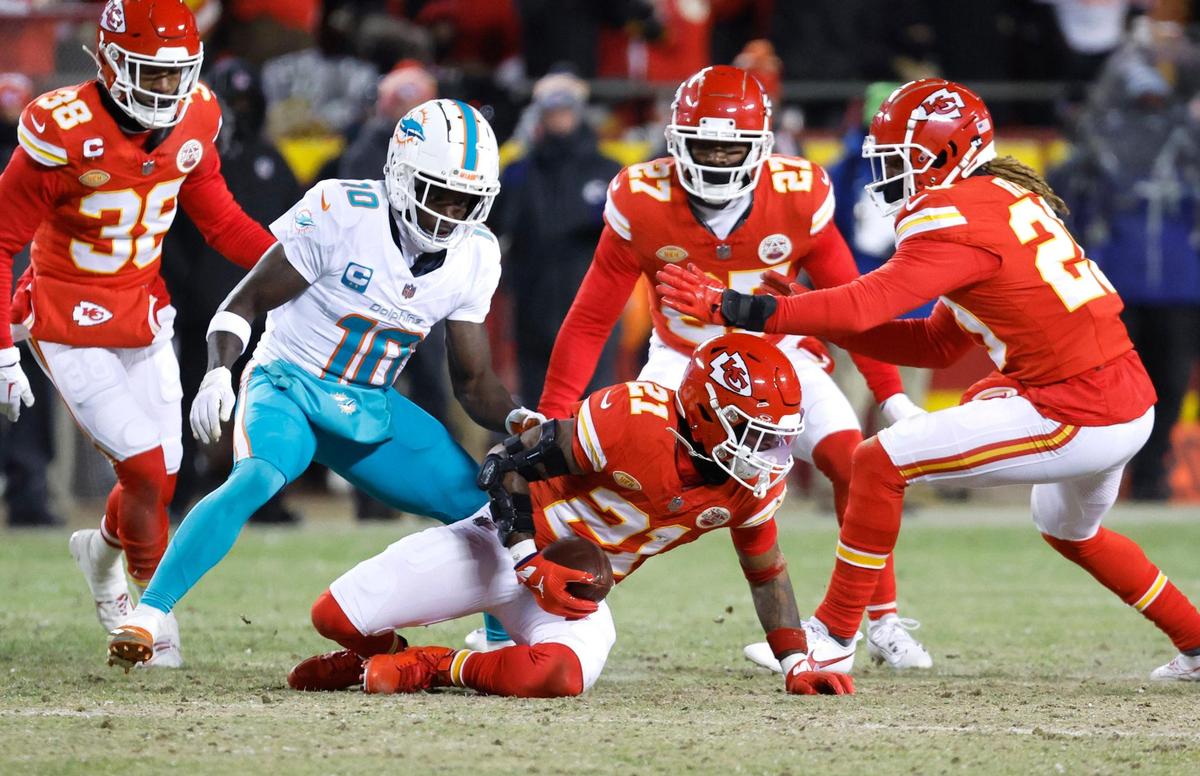 Kansas City Chiefs safety Mike Edwards (21) intercepted a pass intended to Miami Dolphins wide receiver Tyreek Hill (10) during first half of an NFL wild-card playoff football game at GEHA Field at Arrowhead Stadium in Kansas City, Missouri, on Saturday, January 13, 2024.