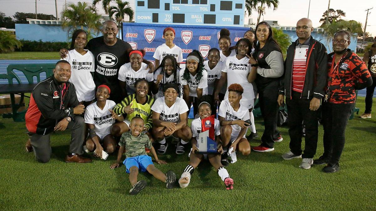 Miami Edison Red Raiders pose with the trophy after winning GMAC Girls Soccer Championship game against Palmetto on Friday, January 12, 2024 at Traz Powell Stadium in Miami. Andrew Uloza / for Miami Herald